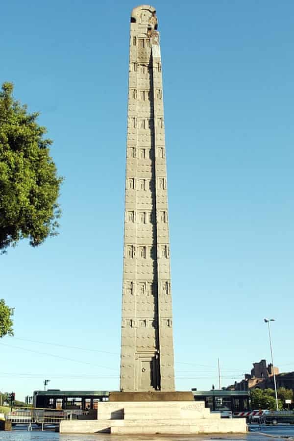 The 1,700-year-old Axum Obelisk, pictured against a clear, azure sky in a piazza in Rome, Italy