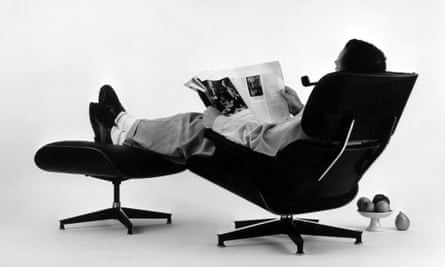 Charles Eames in the plywood Lounge and Ottoman, 1956.