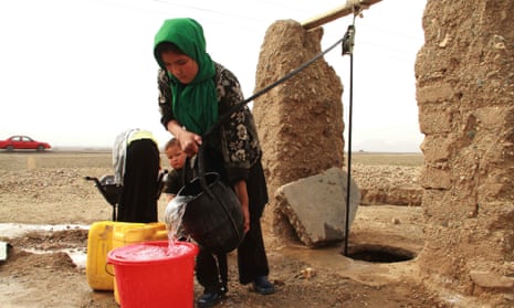 An Afghan girl gets drinking water from a community well, in Herat, Afghanistan.