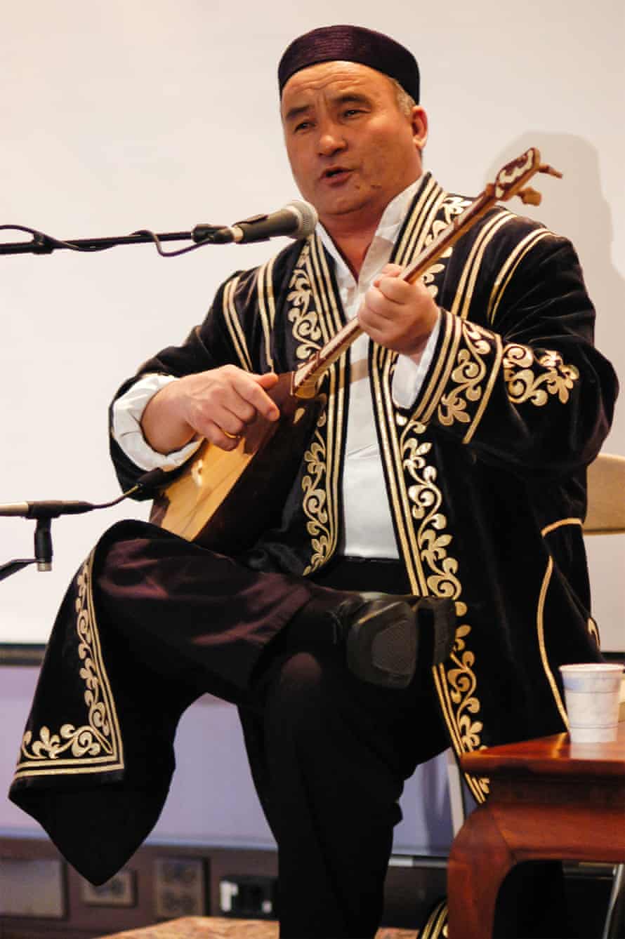 Kazakh musician Almasbek Almatov plays the dombra. Photograph: Linda Vartoogian/Getty Images