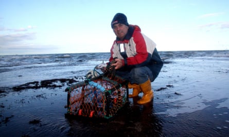 Sean Baxter with his lobster pot on Staithes beach.