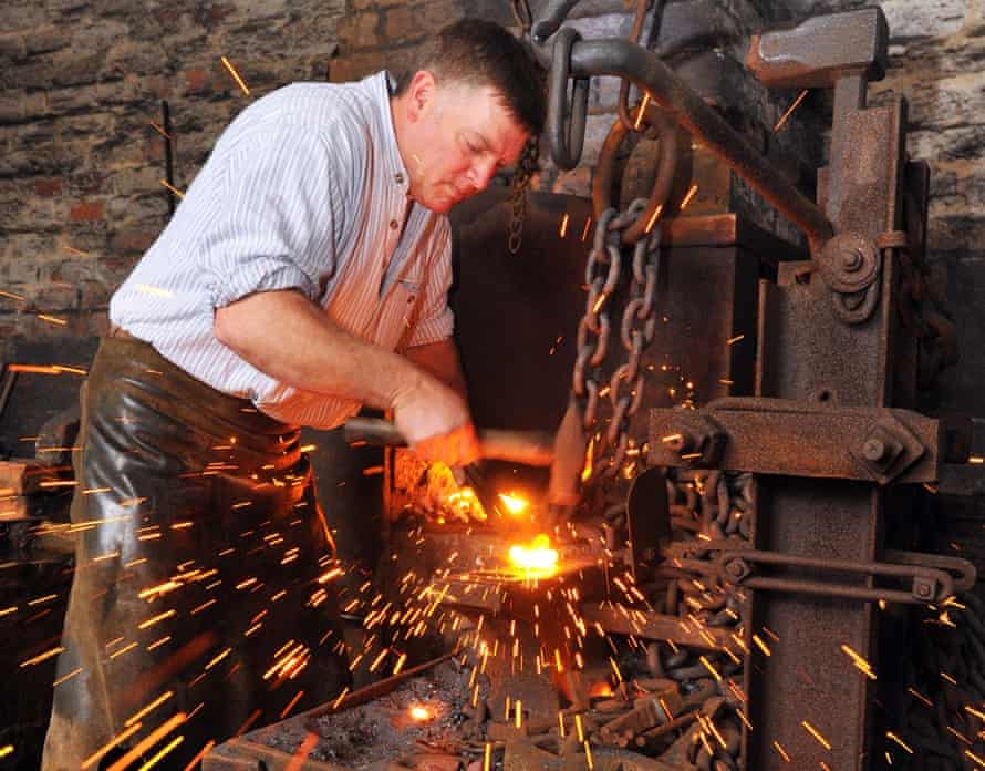 A blacksmith making chains.