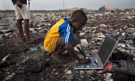 Electronic waste in Agbogbloshie dump, Accra, Ghana. E-waste trash pickers risk their health in search of metals they can sell. 
