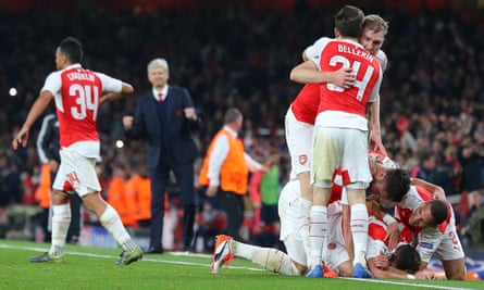 Arsenal’s Mesut Özil is mobbed by team-mates after scoring their second goal against Bayern Munich in their Champions League match.