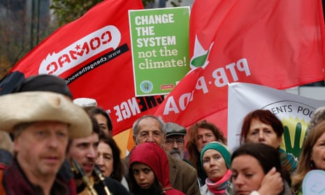 Environmental activists hold placards and banners during a march in Brussels ahead of the Paris  conference on climate change to be held in December in Paris.