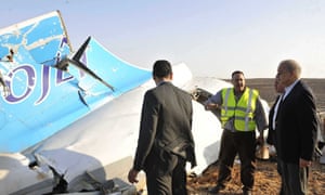Egypt's prime minister, Sherif Ismail, right, examines wreckage