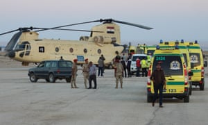 Egyptian officials at Kabret military base in Suez receive the bodies of 34 passengers.