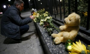 A man lights a candle for the victims outside the Russian embassy in Kiev, Ukraine.
