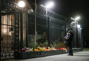 People lay flowers and light candles outside the Russian embassy in Kiev.
