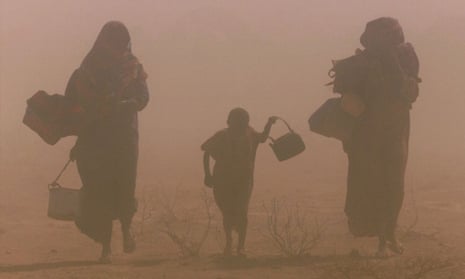 Displaced people walk though a dust storm in drought-stricken southeast Ethiopia.