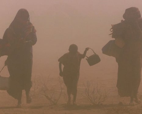 Displaced people walk though a dust storm in drought-stricken southeast Ethiopia.