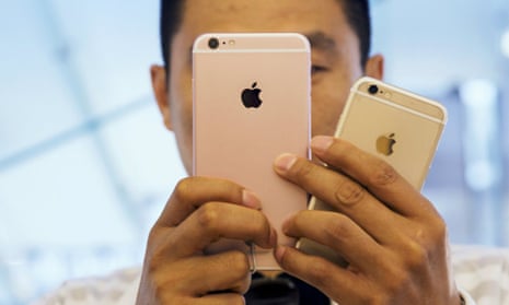 A man takes pictures as Apple iPhone 6s and 6s Plus go on sale at an Apple Store in Beijing, China.