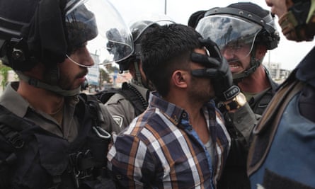 A Palestinian man is arrested by Israeli border police at Friday prayers in Jerusalem. 