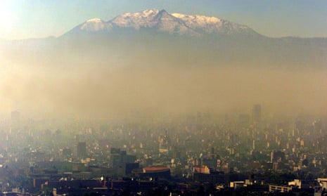 Pollution blankets Mexico city against a backdrop of the Ixtcihuatl volcano 18 January 2002.