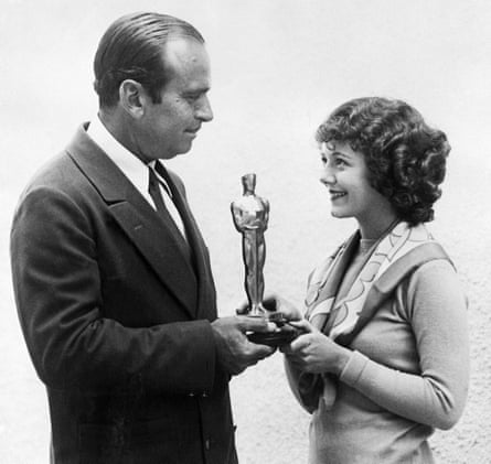 Douglas Fairbanks presents Janet Gaynor with an Oscar for best actress at the first Academy Awards in 1929.