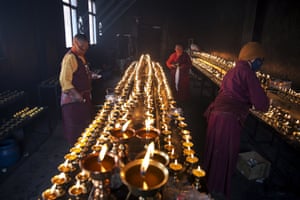 Tibetan Buddhist nuns keep yak butter lamps burning at a Buddhist laymen lodge