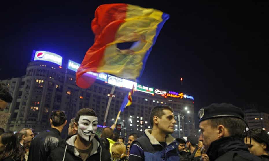 A politically symbolic torn flag flies at demonstrations against demonstrations triggered by the Bucharest nightclub fire.