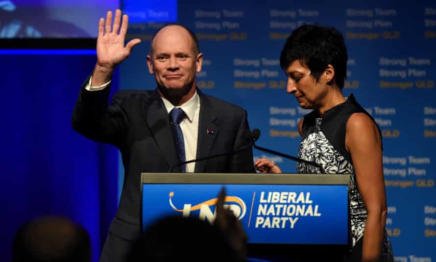Queensland Premier Campbell Newman, flanked by his wife Lisa, waves to the crowed of supporters after conceding defeat in his seat of Ashgrove in the state election in Brisbane.