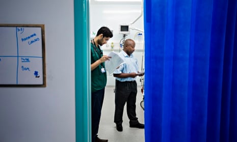 Members of a mental health team talk to a patient in A&E
