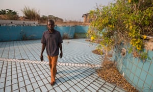 Francois Kosia Ngama in the dried-up swimming pool at the president’s palace.