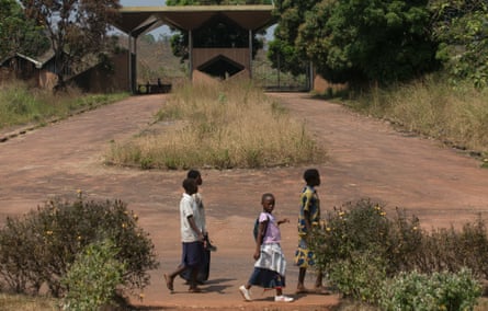 A decaying brown-and-gold gateway still marks the edge of Mobutu’s former estate.