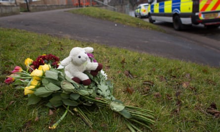 Flowers and a cuddly toy are left for the victims.