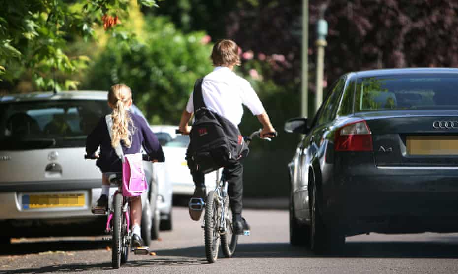 Children cycling along a road