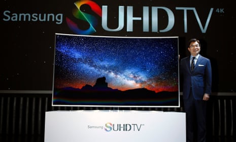 Kim Hyun-seok, head of Samsung Electronics' television division, poses for photographs with a Samsung Electronics S'UHD smart TV during its launch event in Seoul February 5, 2015.