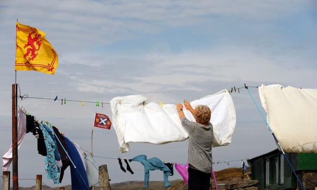 A woman hangs out her washing on the Isle of Lewis in the Outer Hebrides September 11, 2014.