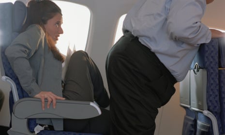 Woman moves her legs to let a man pass on a plane