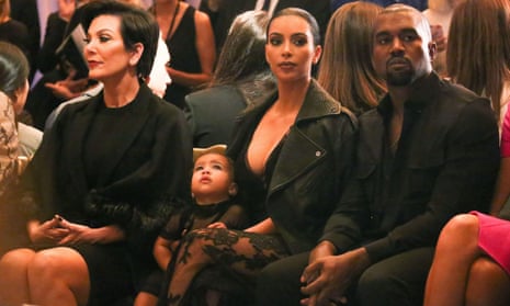 Kim Kardashian and Kanye West at a Paris fashion week show with baby North West