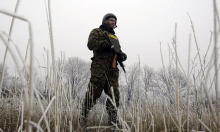 A Ukrainian soldier takes up a position not far from Debaltseve, on 14 February, where fighting has raged in recent days.