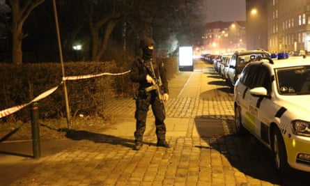 An armed policeman on guard at the site of the attack.