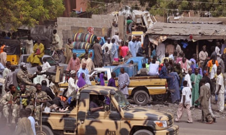Nigerian soldiers in Maiduguri patrol a market following violent Boko Haram attacks in surrounding areas.