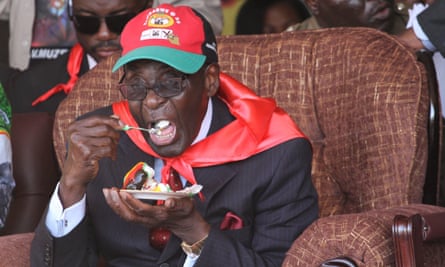 Robert Mugabe eats a piece of cake during a celebration to mark his 88th birthday