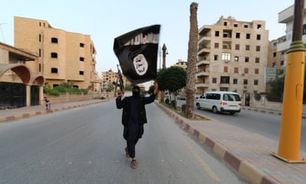 An Islamic State fighter waves a flag in Raqqa.