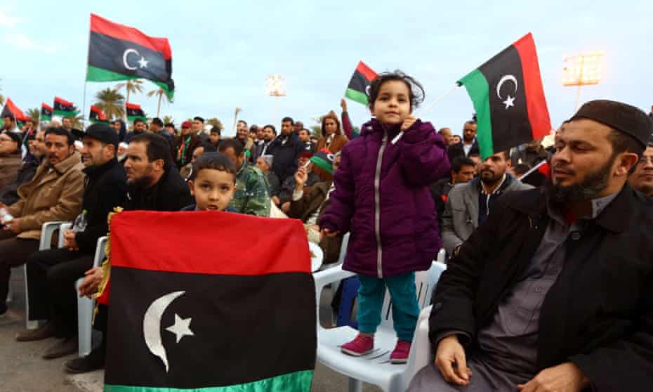 Libyans wave national flags on Martyrs' Square in Tripoli as hundreds of people demonstrated in support of the UN-brokered dialogue between warring factions.