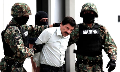 Soldiers escort Joaquin Guzman, known as El Chapo, following his arrest.