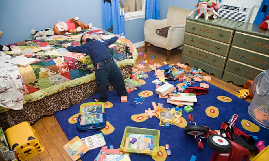 Young boy in messy bedroom