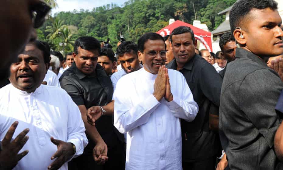 Sri Lankan President Maithripala Sirisena gestures to supporters after speaking outside the Buddhist Temple of Tooth in the central town of Kandy, Sri Lanka.