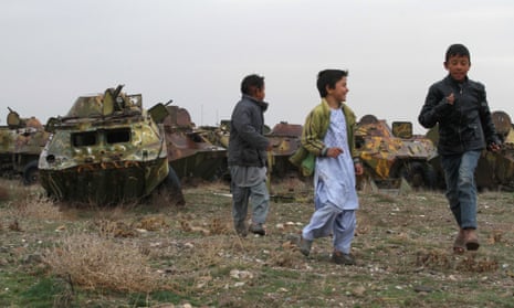 Afghan boys play Soviet-era tank