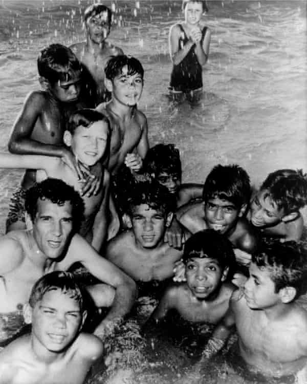 Charles Perkins with a group of Aboriginal children swimming in the spa baths of Moree 