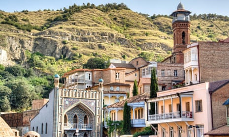 ornate buildings of Tbilisi with hills behind