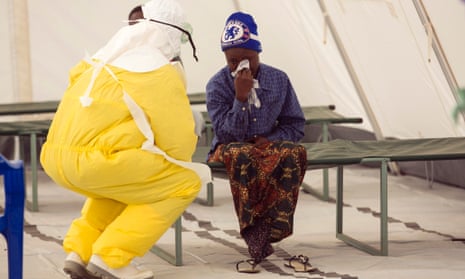 A health worker wearing protective gear attends to a newly admitted suspected Ebola patient in a quarantine zone at a Red Cross facility in the town of Koidu, Kono district in Eastern Sierra Leone in this December 19, 2014 file photo. The rapid response team has arrived and the chaos is easing, but medics in a remote Sierra Leonean district are struggling to control a local Ebola outbreak when it's too late to nip it in the bud. A deployment of medical workers and equipment to Kono District has been the fastest so far in Sierra Leone, a country with nearly half the total Ebola cases,- under a strategy of tackling epidemic hotspots before they get too big. But officials say responses need to be yet faster to fight the fever that has killed more than 7,000 people across West Africa.   REUTERS/Baz Ratner/Files (SIERRA LEONE - Tags: HEALTH DISASTER):rel:d:bm:GM1EACJ1T3W01