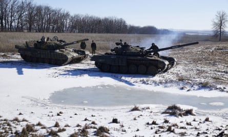 The spoils of war: pro-Russia rebels recover a tank (left) abandoned by retreating Ukrainian troops.