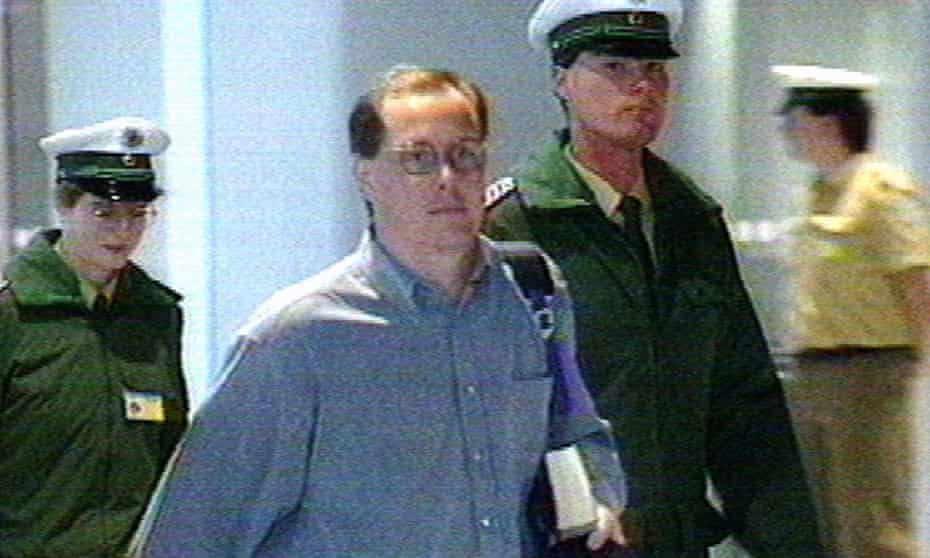 Fugitive Nick Leeson is escorted upon arrival at Frankfurt airport, 2 March 1995.
