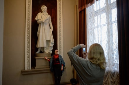 Visitors take pictures with a statue of Alexander Pushkin during the intermission at the Donetsk ballet and opera theatre