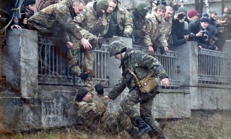 A guard tries to arrest a fighter of the Ayda Ukrainian volunteer battalion in Kiev