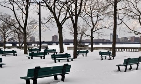 There is an absence of people in this empty park in winter by the Charles River in Boston