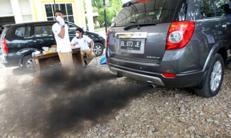An Indonesian Environmental Impact Management Agency (BAPEDAL) employee checks the smoke from the exhaust pipes of a car on a machine, during the automobile emissions inspection in Banda Aceh, Indonesia, 04 July 2012. The Indonesian government will soon rule about Low Cost Green Car to suppress the high rate of pollution due to the increase of motorcycle and vehicles in Indonesia.